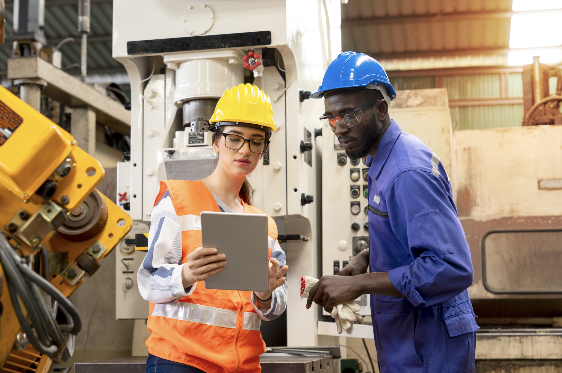 Supervisor, worker with hard hat working in manufacturing factory